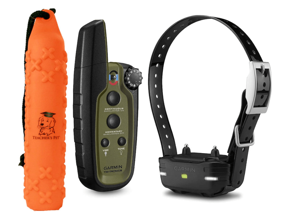 Training tools including an orange chew toy, a Garmin remote control, and a Garmin bark limiter collar.